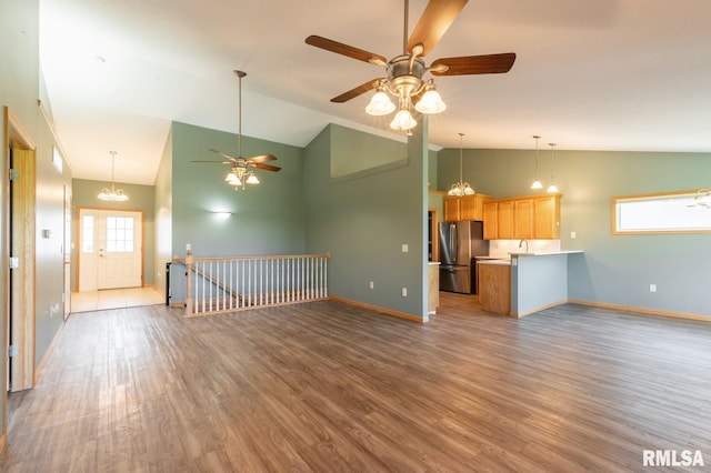 unfurnished living room featuring baseboards, wood finished floors, ceiling fan, and high vaulted ceiling