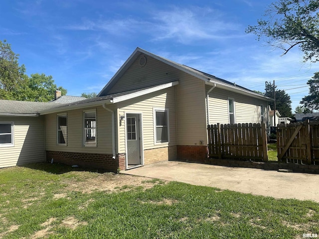 812 E Murray St, Macomb, IL 61455 - view of property exterior featuring a patio, a chimney, and brick siding