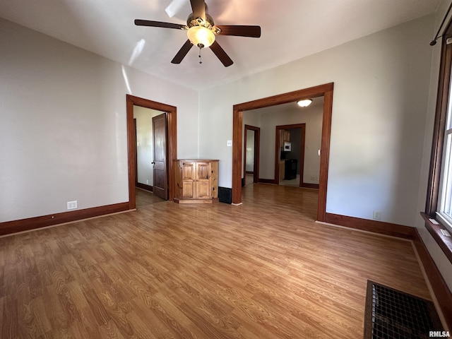 812 E Murray St, Macomb, IL 61455 - unfurnished room featuring light wood-style floors, baseboards, and ceiling fan