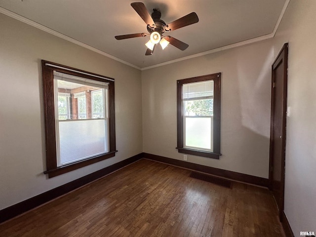 812 E Murray St, Macomb, IL 61455 - spare room featuring healthy amount of natural light, dark wood-style floors, baseboards, and crown molding