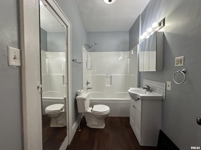 812 E Murray St, Macomb, IL 61455 - full bathroom featuring toilet, wood finished floors, vanity, and shower / bathtub combination
