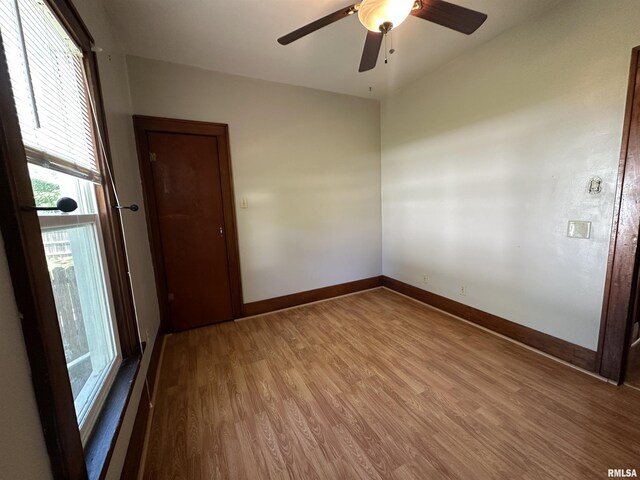 812 E Murray St, Macomb, IL 61455 - spare room featuring wood finished floors, baseboards, and a ceiling fan