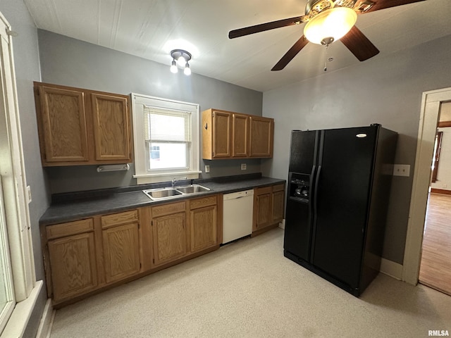 812 E Murray St, Macomb, IL 61455 - kitchen with black refrigerator with ice dispenser, a sink, white dishwasher, dark countertops, and brown cabinetry