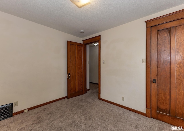 1010 S 6th St, Clinton, IA 52732 - unfurnished bedroom with carpet flooring and a textured ceiling