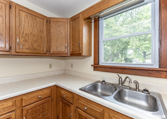 1010 S 6th St, Clinton, IA 52732 - kitchen with light countertops, a textured ceiling, and brown cabinets