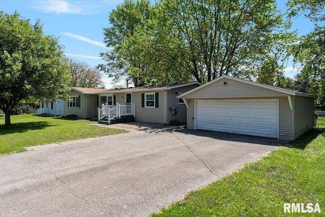 ranch-style home with a garage and a front lawn