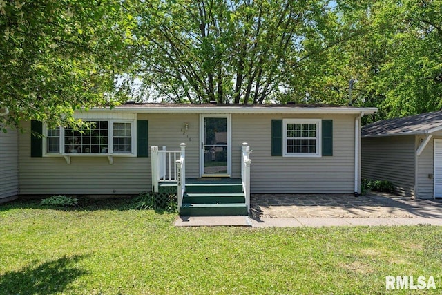 view of front facade with a front yard and a patio area
