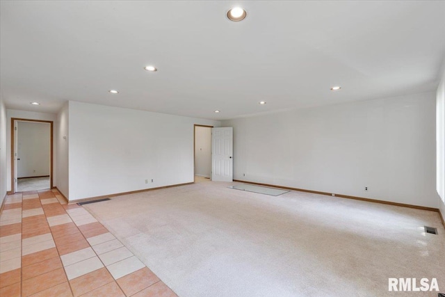 spare room featuring recessed lighting, baseboards, and light tile patterned flooring