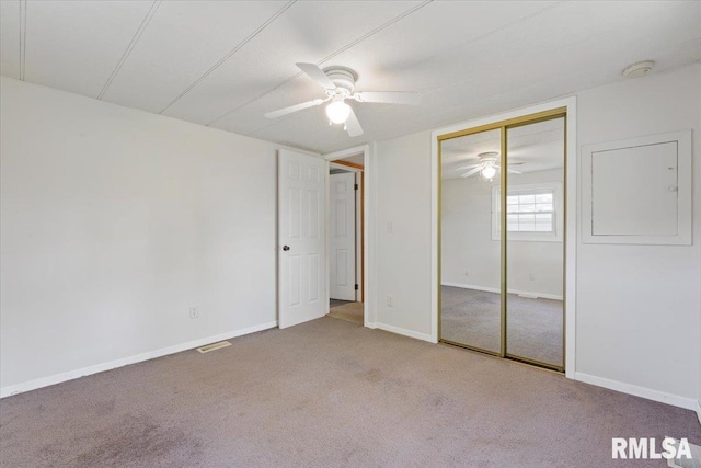 unfurnished bedroom featuring carpet flooring, a closet, a ceiling fan, and baseboards