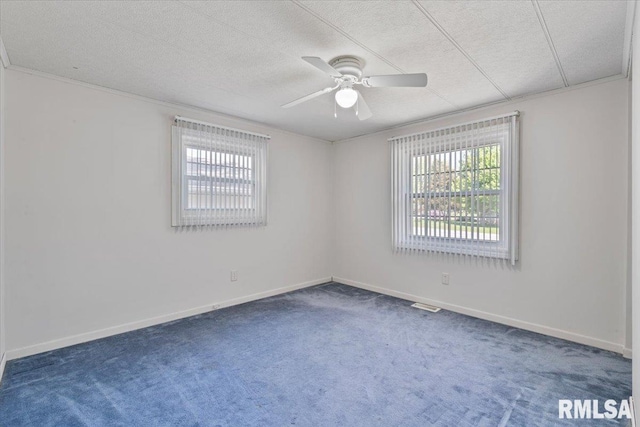 spare room featuring carpet floors, a textured ceiling, ceiling fan, and baseboards
