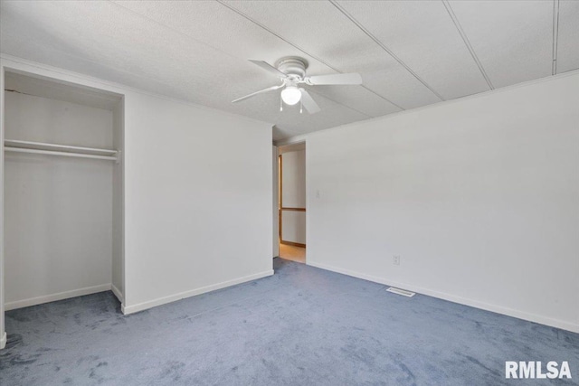 unfurnished bedroom with carpet floors, a closet, and baseboards