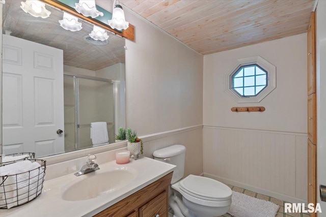 full bath featuring wooden ceiling, a shower stall, vanity, a wainscoted wall, and toilet