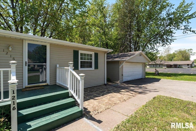 view of front of house featuring a garage and an outbuilding