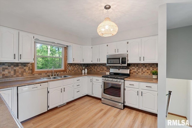 1401 265th St, Sherrard, IL 61281 - kitchen featuring stainless steel appliances, a sink, white cabinetry, and light wood finished floors