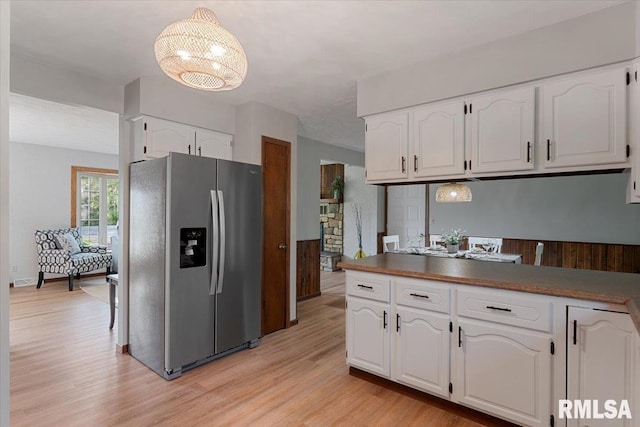 1401 265th St, Sherrard, IL 61281 - kitchen with stainless steel fridge with ice dispenser, light wood-style flooring, white cabinets, and pendant lighting