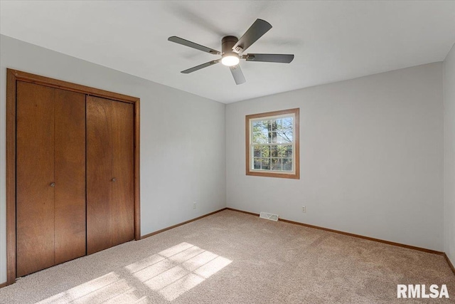 1401 265th St, Sherrard, IL 61281 - unfurnished bedroom featuring carpet flooring, baseboards, a closet, and a ceiling fan