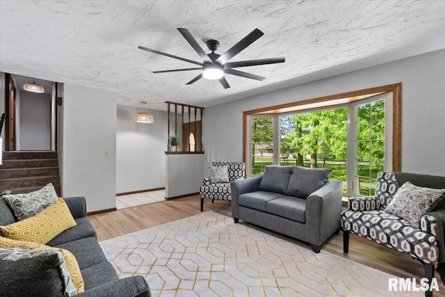 1401 265th St, Sherrard, IL 61281 - living area with wood finished floors, stairs, a textured ceiling, and ceiling fan
