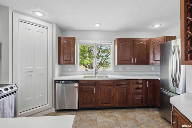 13218 300th St, Donahue, IA 52746 - kitchen with appliances with stainless steel finishes, a sink, light countertops, and recessed lighting