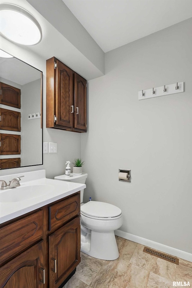 13218 300th St, Donahue, IA 52746 - bathroom with toilet, vanity, and baseboards