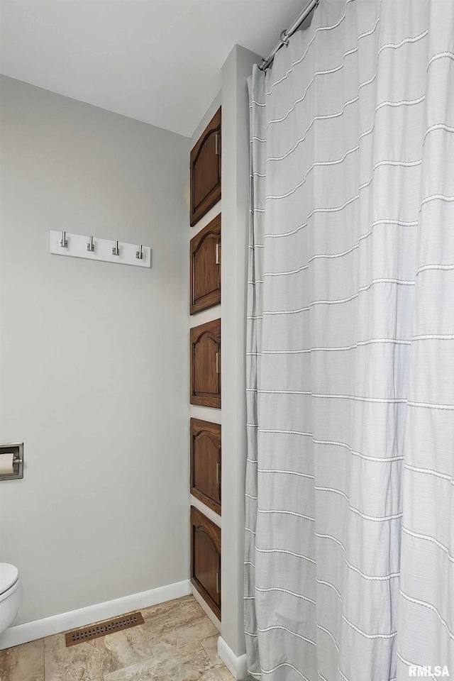13218 300th St, Donahue, IA 52746 - bathroom with baseboards, toilet, and a shower with curtain