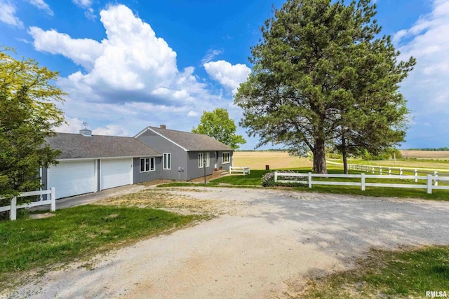 13218 300th St, Donahue, IA 52746 - ranch-style house featuring a garage and driveway