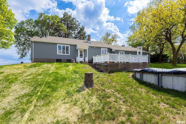 13218 300th St, Donahue, IA 52746 - rear view of house with a deck, a yard, and a chimney