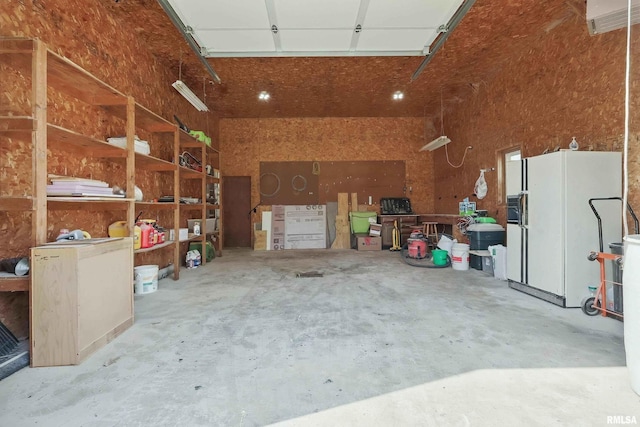 13218 300th St, Donahue, IA 52746 - garage featuring white fridge with ice dispenser