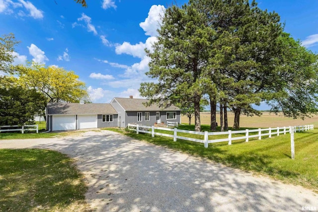 13218 300th St, Donahue, IA 52746 - ranch-style house with dirt driveway and a garage