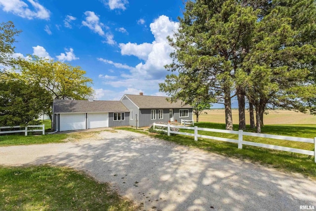 13218 300th St, Donahue, IA 52746 - ranch-style house with driveway and an attached garage