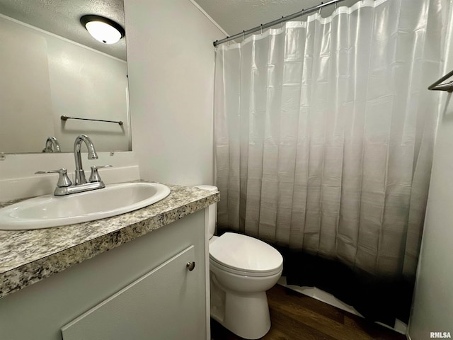 806 Boyd St, Eldorado, IL 62930 - full bathroom with wood finished floors, toilet, vanity, a shower with shower curtain, and ornamental molding
