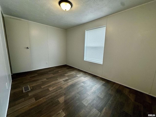 806 Boyd St, Eldorado, IL 62930 - empty room featuring dark wood-style floors and a textured ceiling