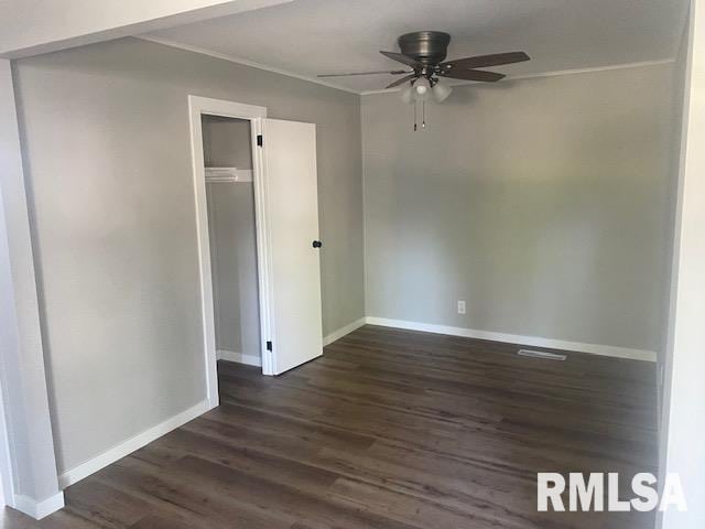 2712 30th St, Rock Island, IL 61201 - unfurnished room featuring dark wood-type flooring, a ceiling fan, baseboards, and ornamental molding
