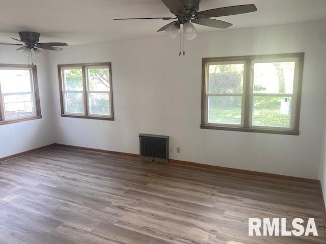 2712 30th St, Rock Island, IL 61201 - empty room with ceiling fan, wood finished floors, and baseboards