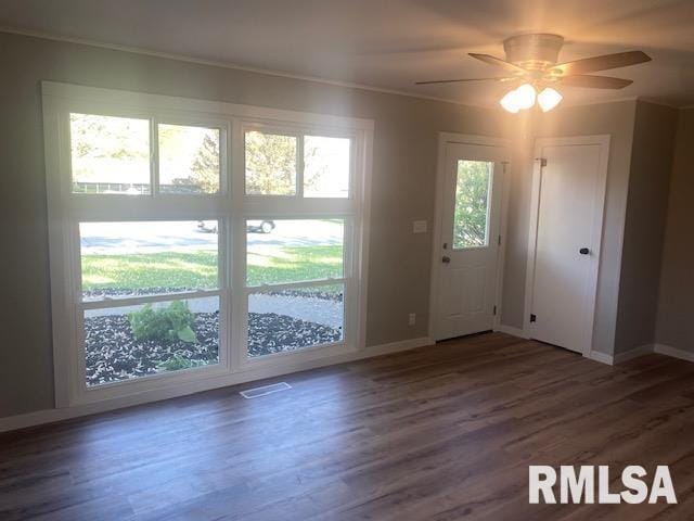 2712 30th St, Rock Island, IL 61201 - doorway featuring baseboards, wood finished floors, a ceiling fan, and ornamental molding