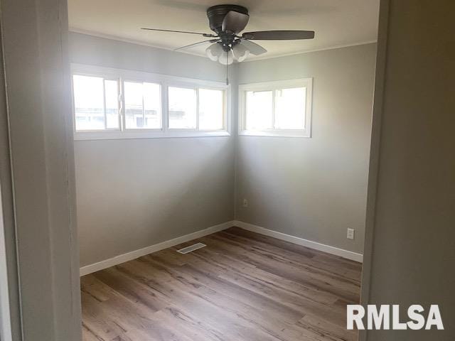 2712 30th St, Rock Island, IL 61201 - empty room featuring ornamental molding, wood finished floors, ceiling fan, and baseboards