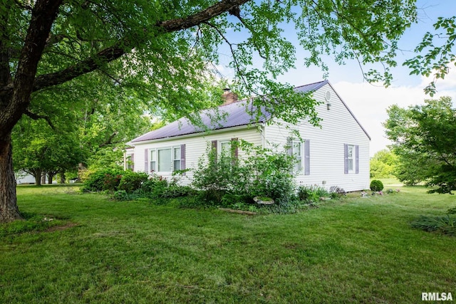 6868 Rte 37, Marion, IL 62959 - view of side of property featuring a chimney, a yard, and metal roof