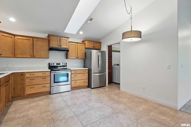 kitchen with appliances with stainless steel finishes, under cabinet range hood, vaulted ceiling, light countertops, and a skylight