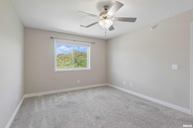 unfurnished room featuring carpet floors, a ceiling fan, and baseboards
