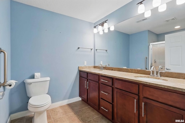 bathroom featuring toilet, a stall shower, baseboards, and tile patterned flooring