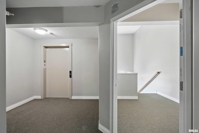 hall with carpet flooring, an upstairs landing, and baseboards