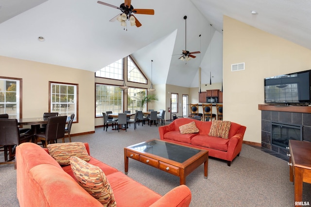 living area with high vaulted ceiling, carpet flooring, ceiling fan, and baseboards