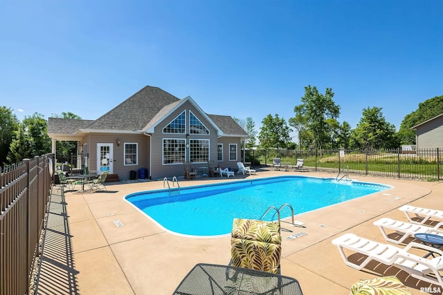 community pool featuring a patio and fence