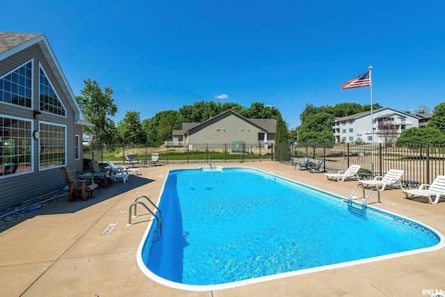 community pool featuring a patio area and fence