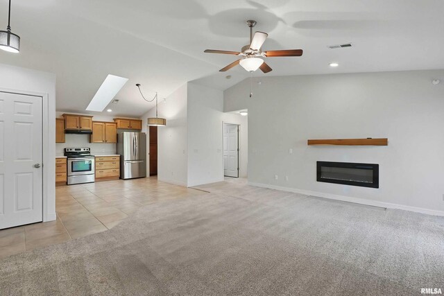 unfurnished living room with lofted ceiling, a ceiling fan, light carpet, baseboards, and a glass covered fireplace