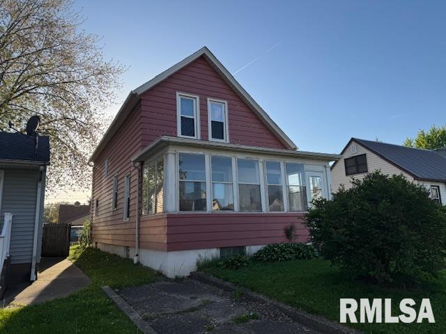 view of side of home featuring a sunroom