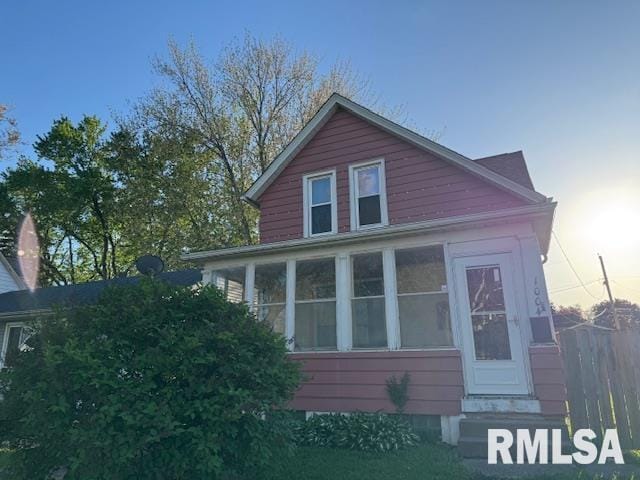 view of side of home featuring a sunroom