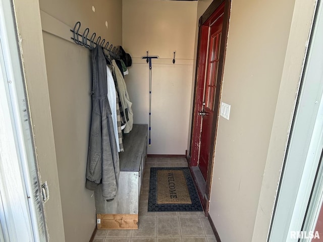 mudroom featuring tile patterned flooring and baseboards
