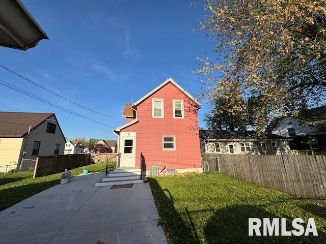 rear view of house with a patio and central AC unit