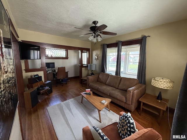 living room with a desk, ceiling fan, a textured ceiling, and wood finished floors