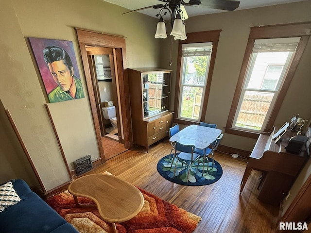 dining area featuring ceiling fan, light wood finished floors, and baseboards